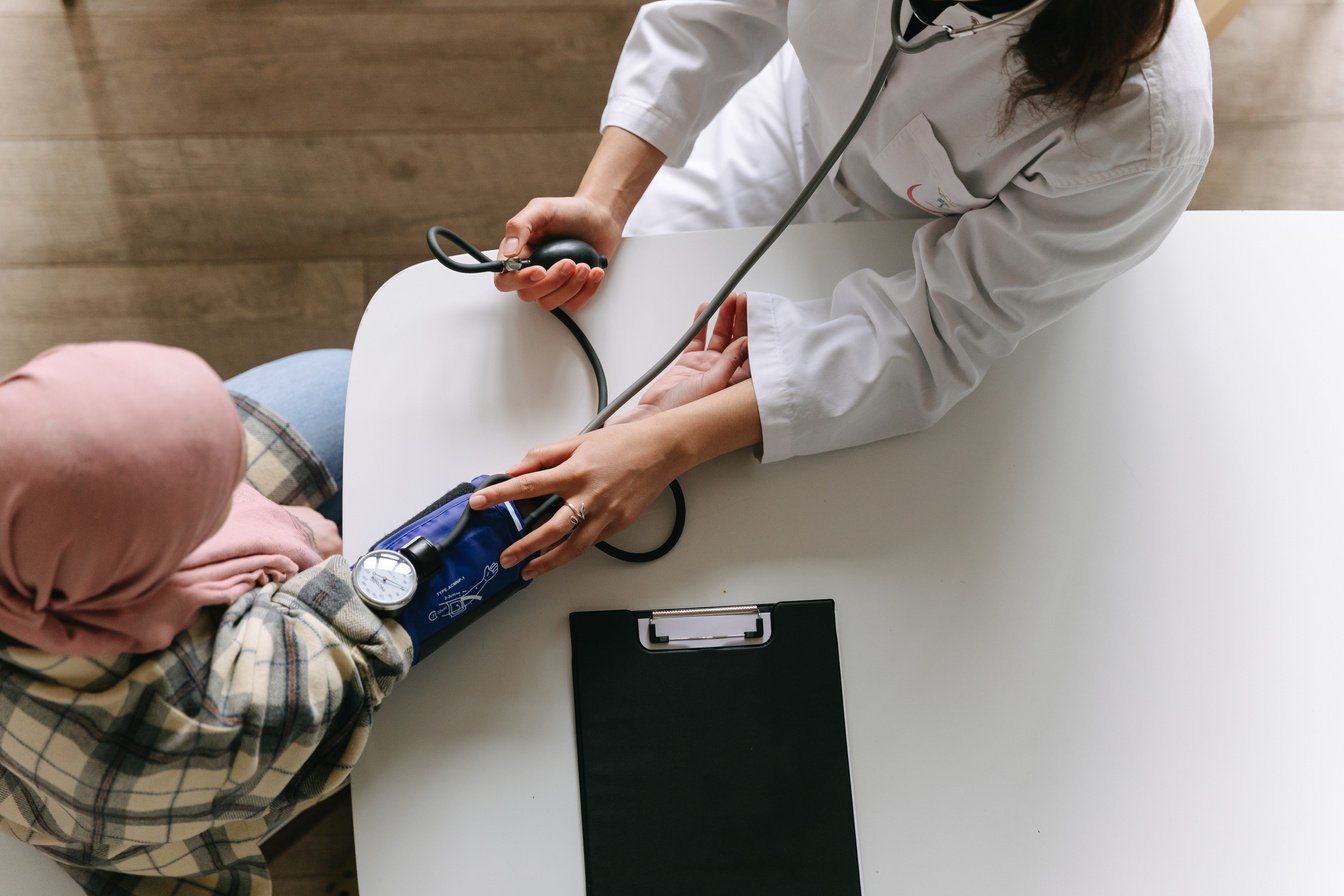 A Doctor Taking Patient's Blood Pressure